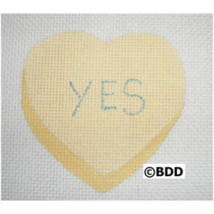 A heart shaped canvas with the word " yes " written on it.