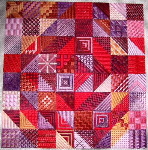 A quilt made of different colors and patterns.