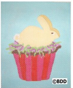 A painting of a bunny sitting on top of a cupcake.