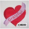 A red heart with the word grateful on it.