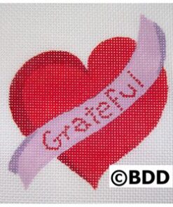 A red heart with the word grateful on it.