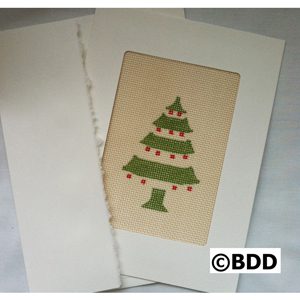 A christmas tree card is shown on the front of a white paper.