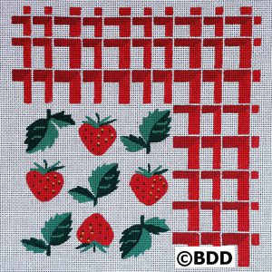 A cross stitch pattern of strawberries on the fabric.