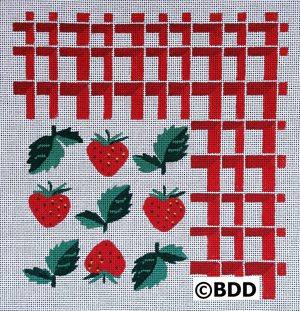 A cross stitch pattern of strawberries on the fabric.