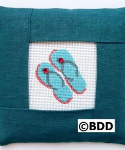 A blue pillow with a pair of flip flops on it.