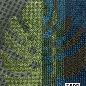 A close up of the fabric with green and blue designs.