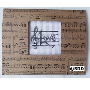 A picture frame with musical notes and the word love.