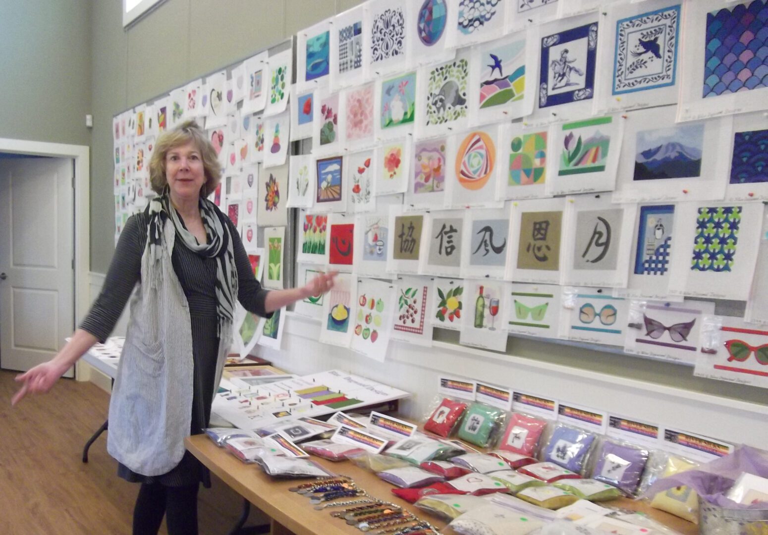 A woman standing in front of a table with many cards on it.