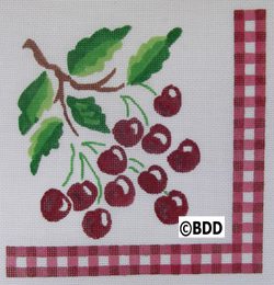 A red and white checkered napkin with cherries on it.