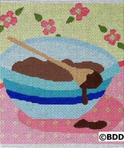 A bowl of chocolate covered dough on a pink and blue table.