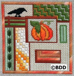 A cross stitch pattern of an orange pumpkin and a black bird.