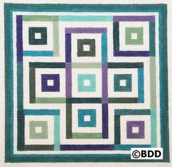 A square shaped needlepoint of squares in different colors.