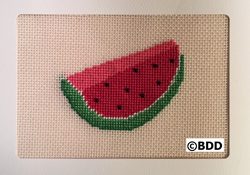 A cross stitch picture of a watermelon.