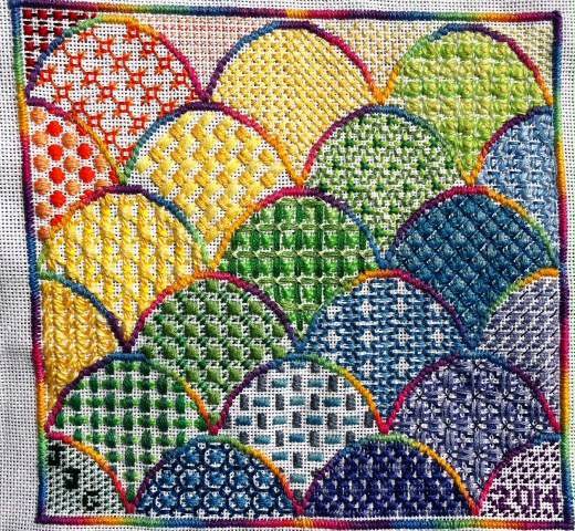 A colorful needlepoint pattern of fish scales.