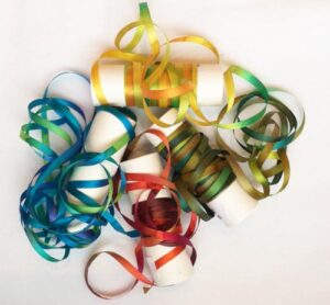 A bunch of colorful ribbons are laying on the table