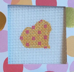 A heart with polka dots on it in front of colorful circles.