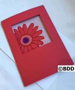A red card with a flower in the middle of it.