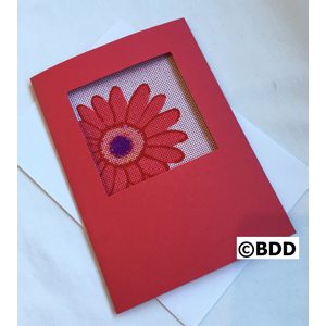 A red card with a flower in the middle of it.