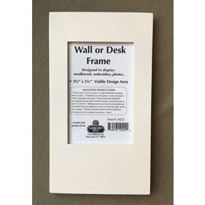 A white picture frame with a photo of the back side.