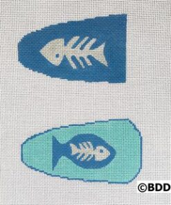 Two fish shaped needlepoint canvases with a blue background.