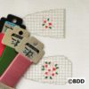 A group of four tags with different designs on them.