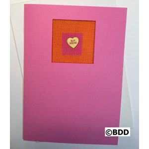 A pink card with a heart on it.