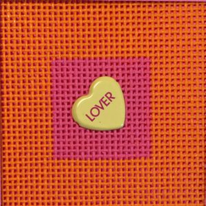 A yellow heart with the word " lover " on it.