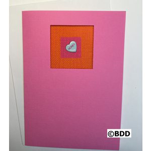 A pink and orange card with a heart on it.