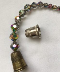 A close up of a bead and a thimble