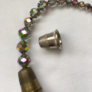 A close up of a bead and a thimble