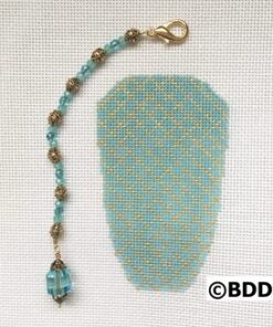 A blue bead is attached to the back of a piece of fabric.