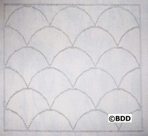 A white cloth with a pattern of scallops.