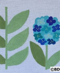 A blue flower and leaves are on the ground.