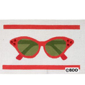 A red pair of sunglasses with green lenses.