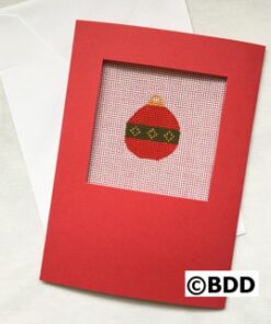 A red card with an ornament on it.