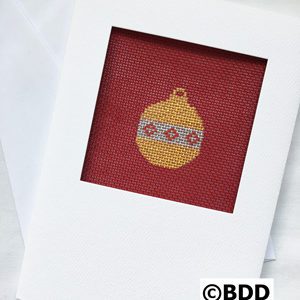 A red and yellow christmas ornament is in the frame.