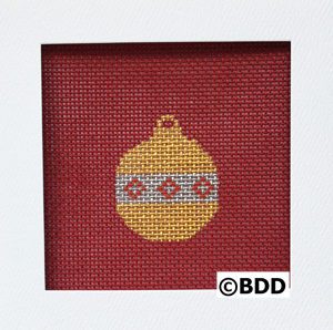 A red and yellow ornament is in the middle of a frame.