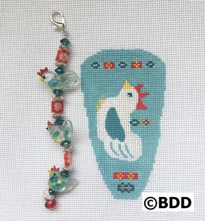 A blue and white bird with beads on it's tail.