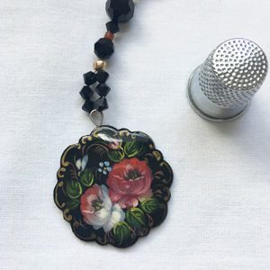 A close up of a necklace with flowers