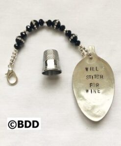 Stitched spoon with thimble and beaded chain.