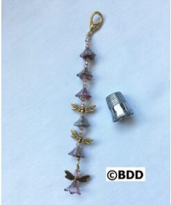 A key chain with five little dragonflies on it.