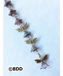 A long necklace with purple and gold beads.