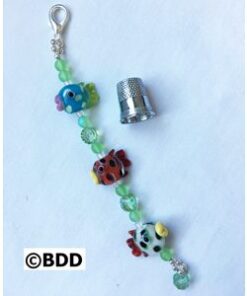 A keychain with beads and a thimble
