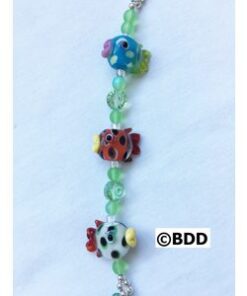 A bracelet with three different colored fish on it.