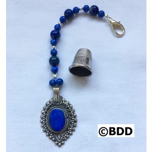 A blue bead and silver key chain with a thimble.