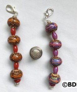 A pair of beads with a button on the back.