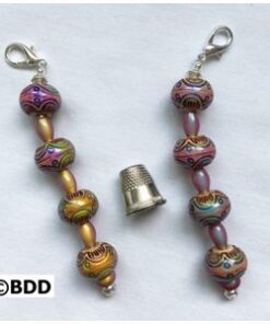 A pair of beads with a thimble on the end.