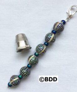 A thimble and bead key chain with a thimble