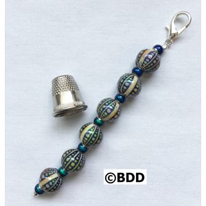 A thimble and bead key chain with a thimble