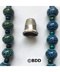 A close up of a thimble on beads